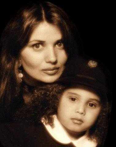 Stevanna Jackson in a black uniform with white collar and black hat with her mother in a black dress.